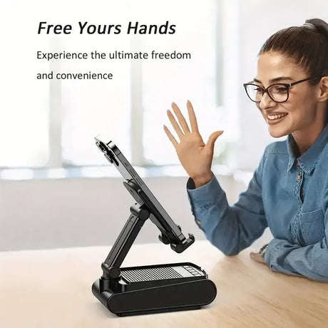 A woman sitting at a desk with her hands up