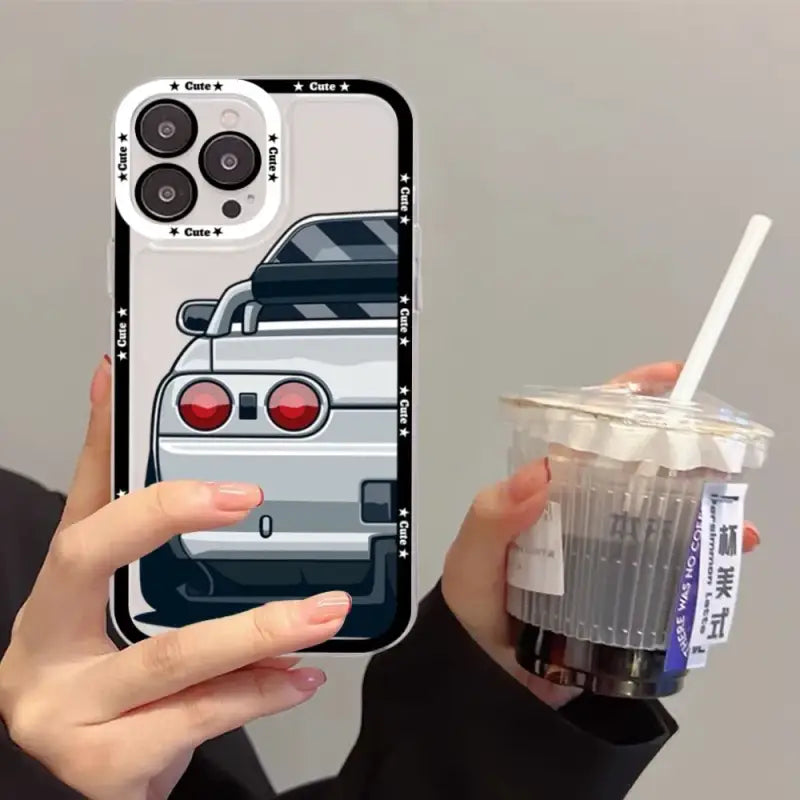 A woman holding a drink and a cell phone case