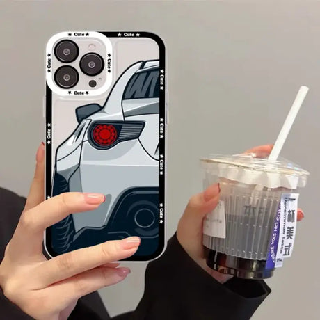 A woman holding a drink and a phone case