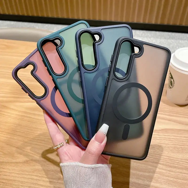 a woman holding up four iphone cases
