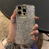 A woman holding a glitter phone case