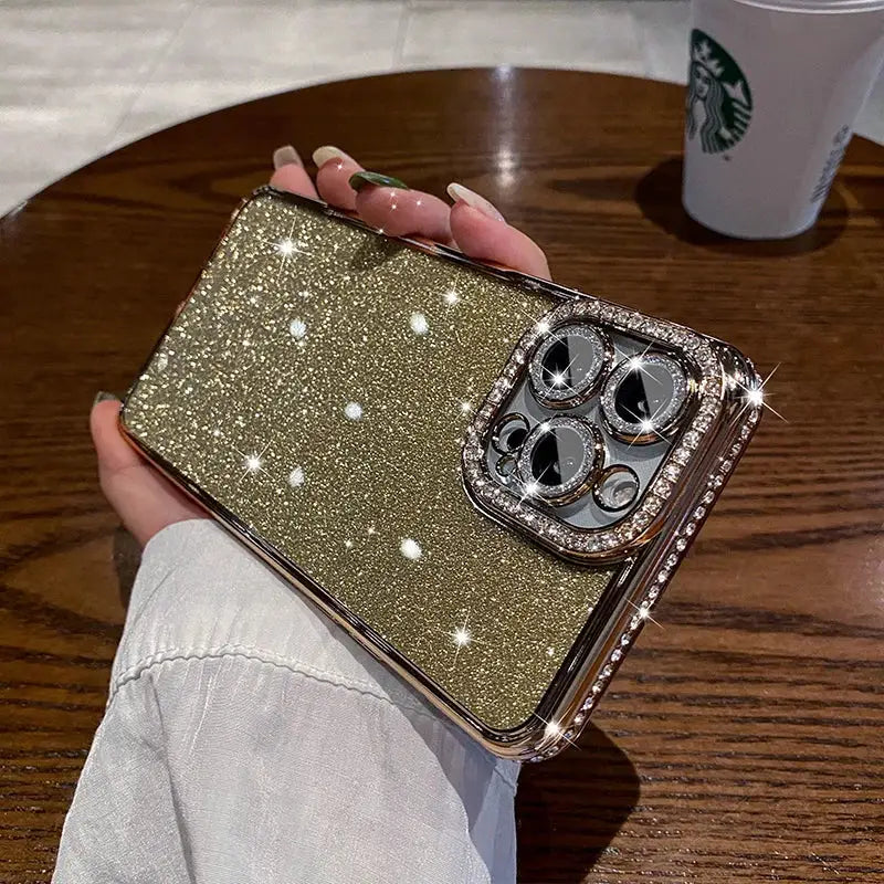 a woman holding a gold glitter phone case