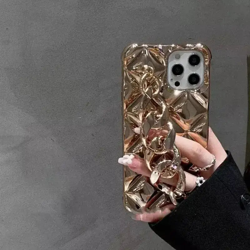 a woman holding a gold phone case