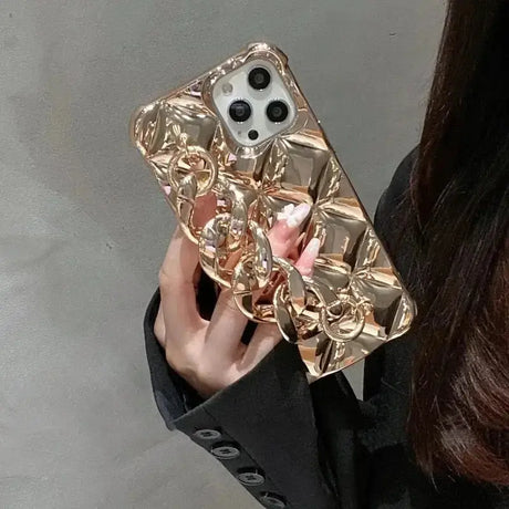 A woman holding a gold phone case