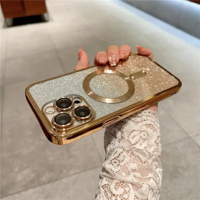 a woman holding a gold phone case with two rings