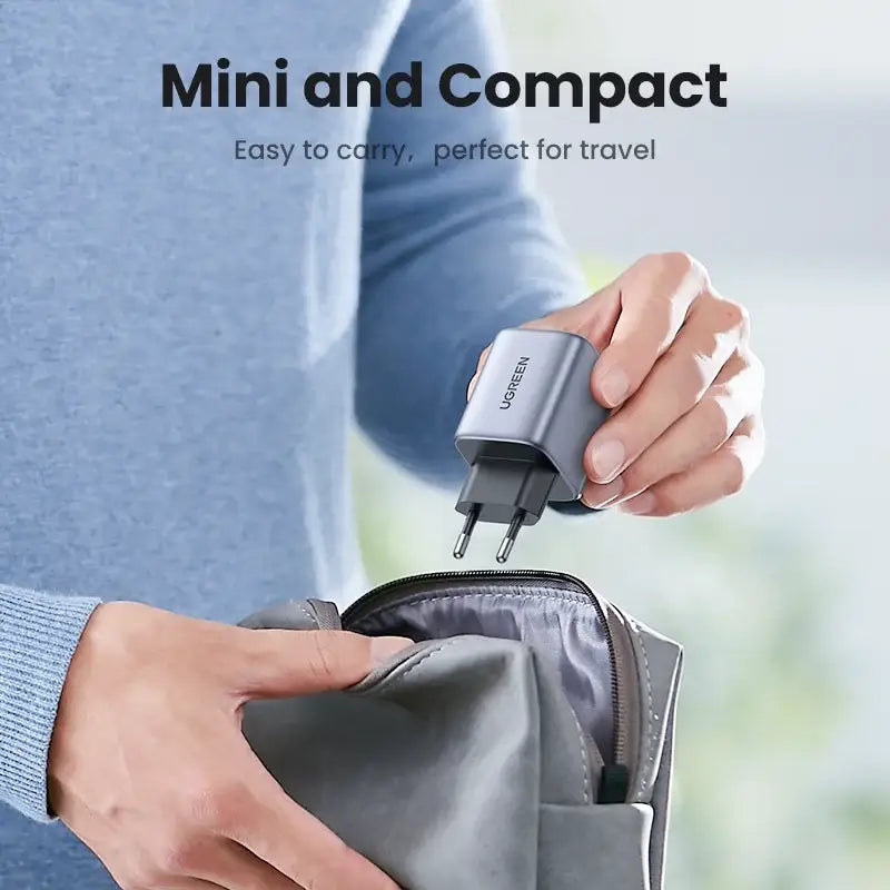 A woman holding a gray travel bag