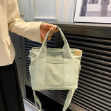 a woman holding a green bag in front of a black and white photo