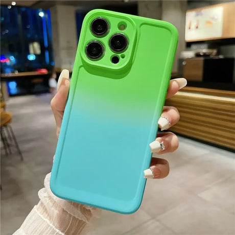 A woman holding a green and blue iphone case