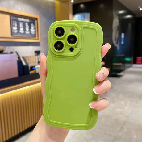 A woman holding a green iphone case