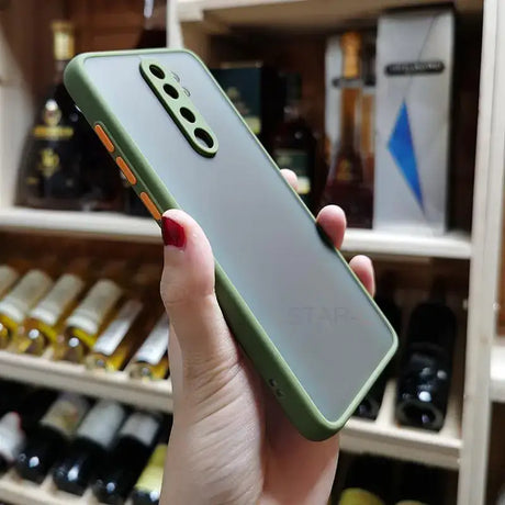 A woman holding a green iphone case in her hand