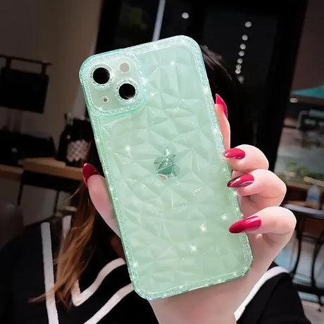 a woman holding a green phone case