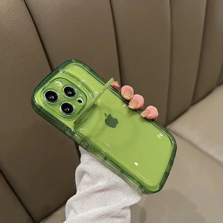 A woman holding a green phone case