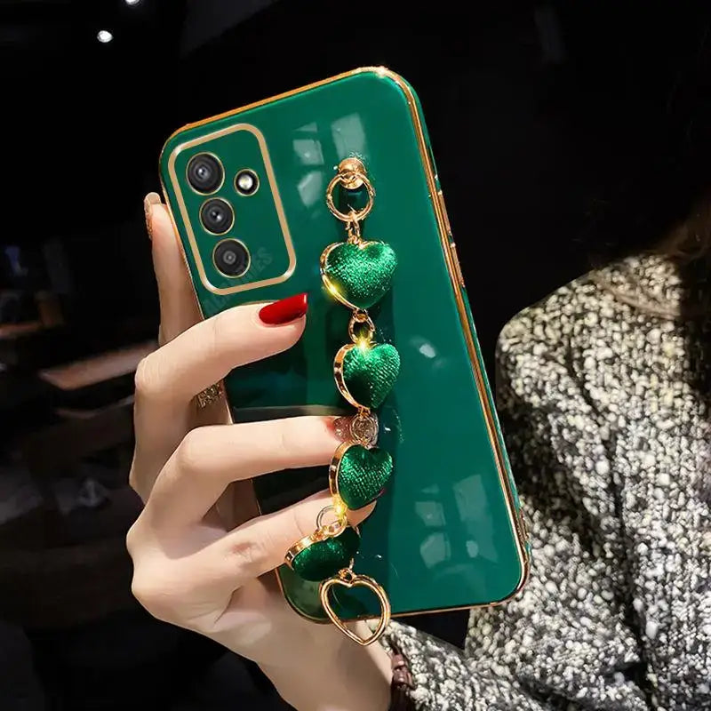 a woman holding a green phone case with a gold ring