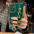 a woman holding a green phone case with a ring