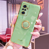 a woman holding a green phone case with a gold ring