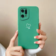 A woman holding a green phone case with a heart drawn on it