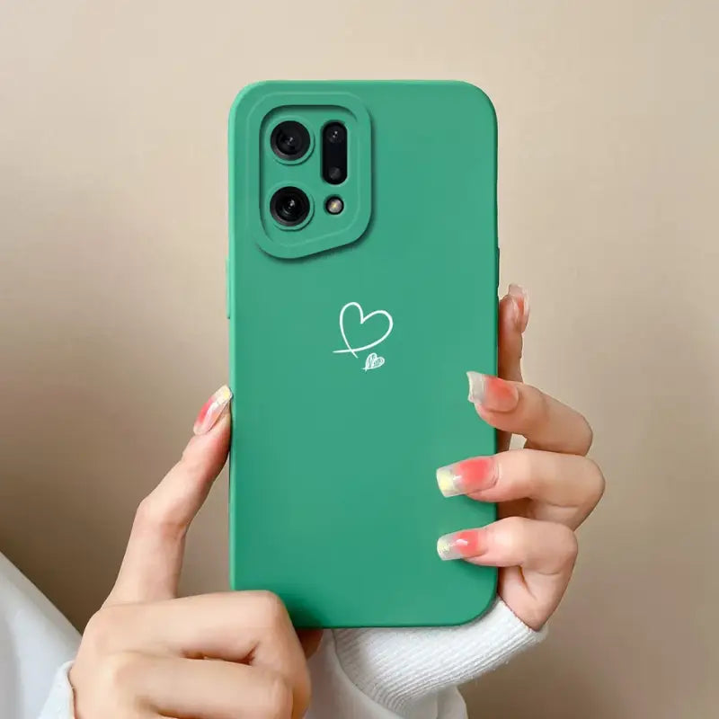A woman holding a green phone case with a heart drawn on it