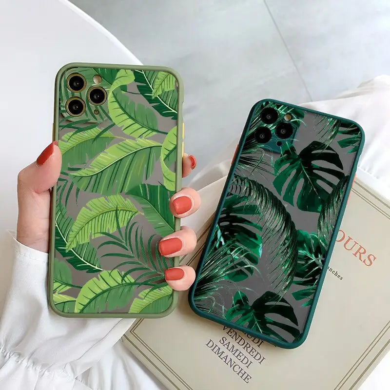 a woman holding a green phone case with a green leaf print