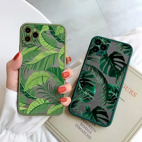 A woman holding a green phone case with a green leaf print