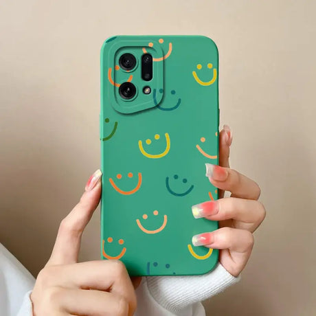 A woman holding a green phone case with smiley faces