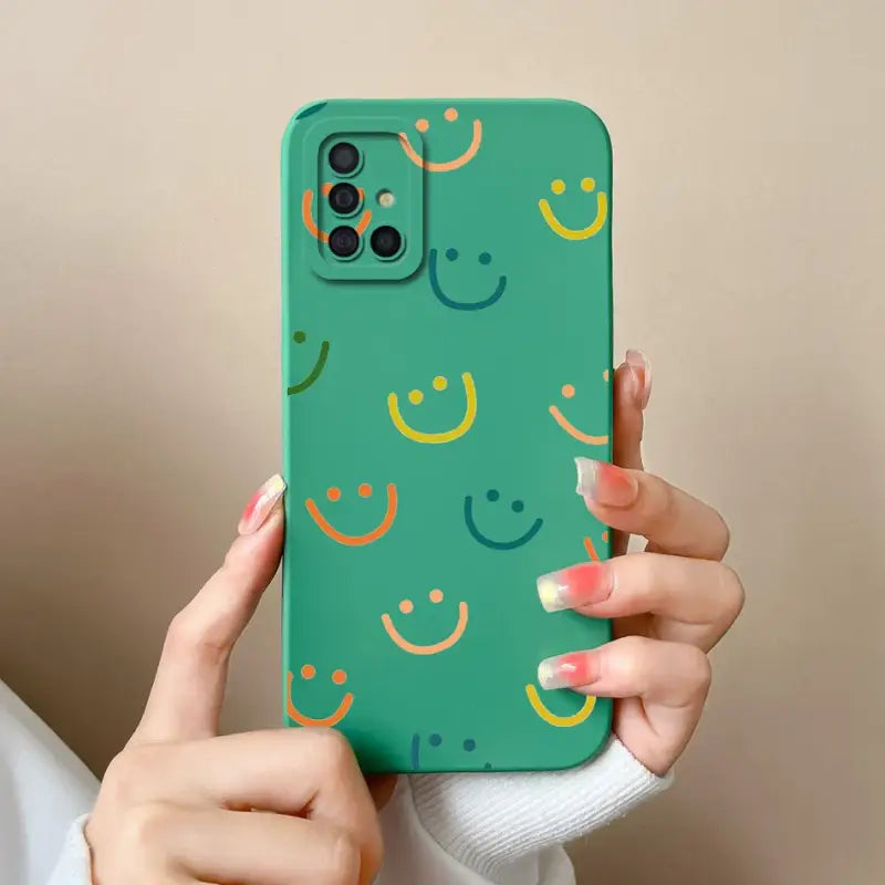a woman holding a green phone case with smiley faces