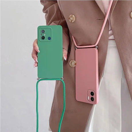 a woman holding a green and pink phone case