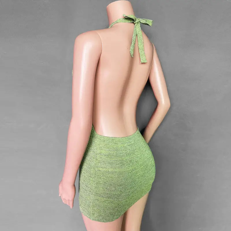 a green swimsuit with a halt neck and a green tie around the back