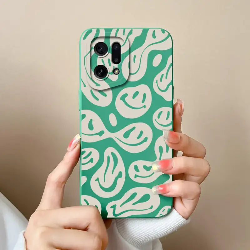 a woman holding a green and white phone case
