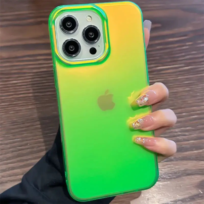 a woman holding a green and yellow iphone case