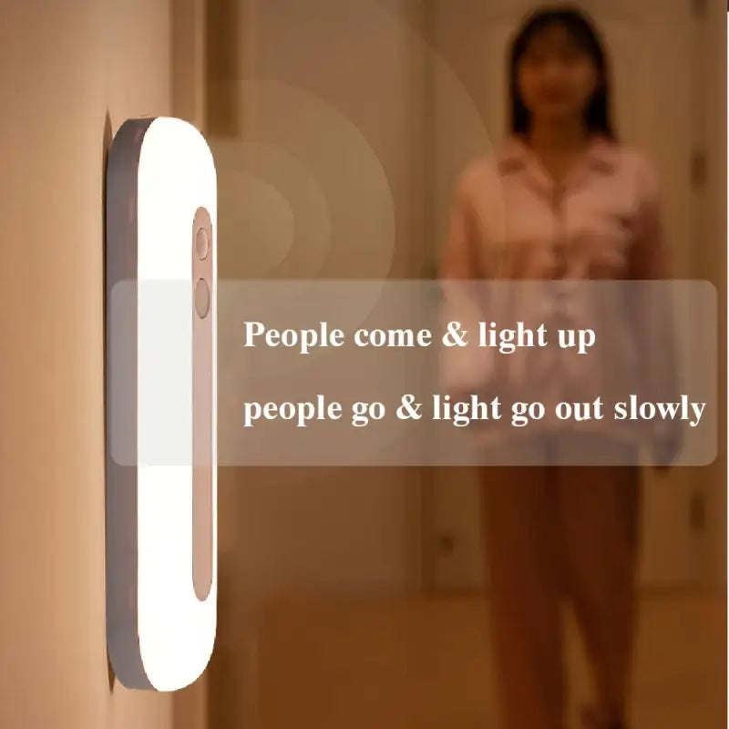 a woman is standing in the hallway with a light on