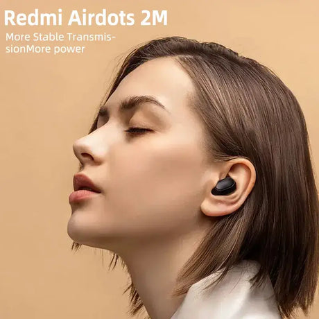 A woman with her head tilted to the side, wearing a pair of bluetooth earphones