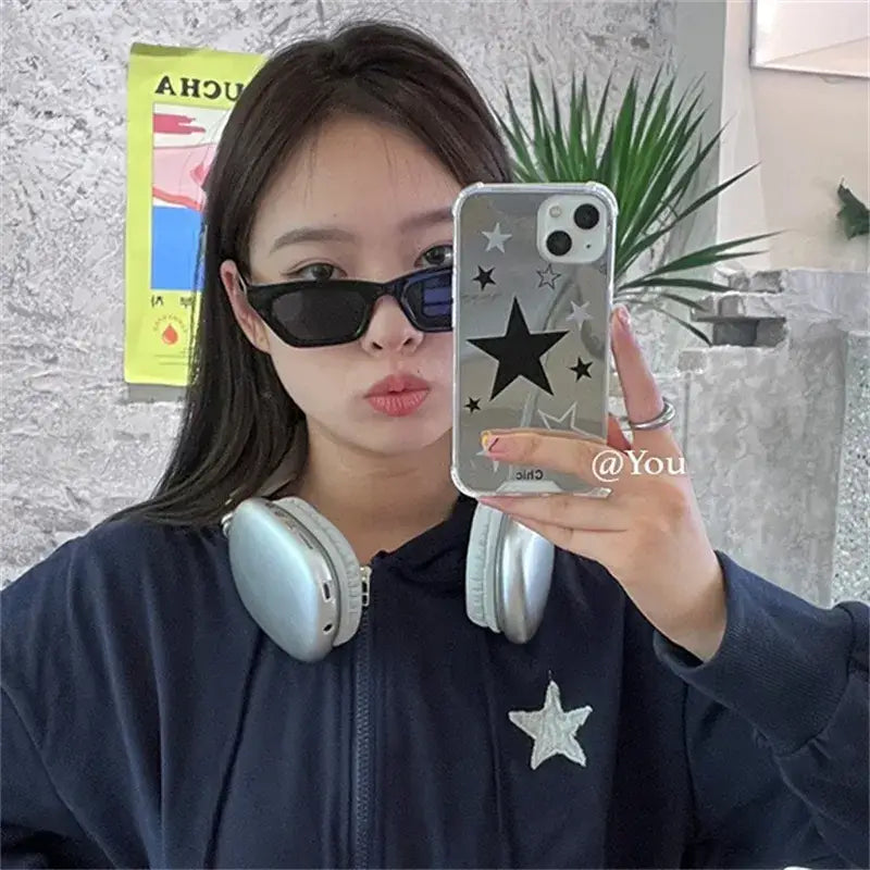 a woman wearing headphones and sunglasses taking a selfie