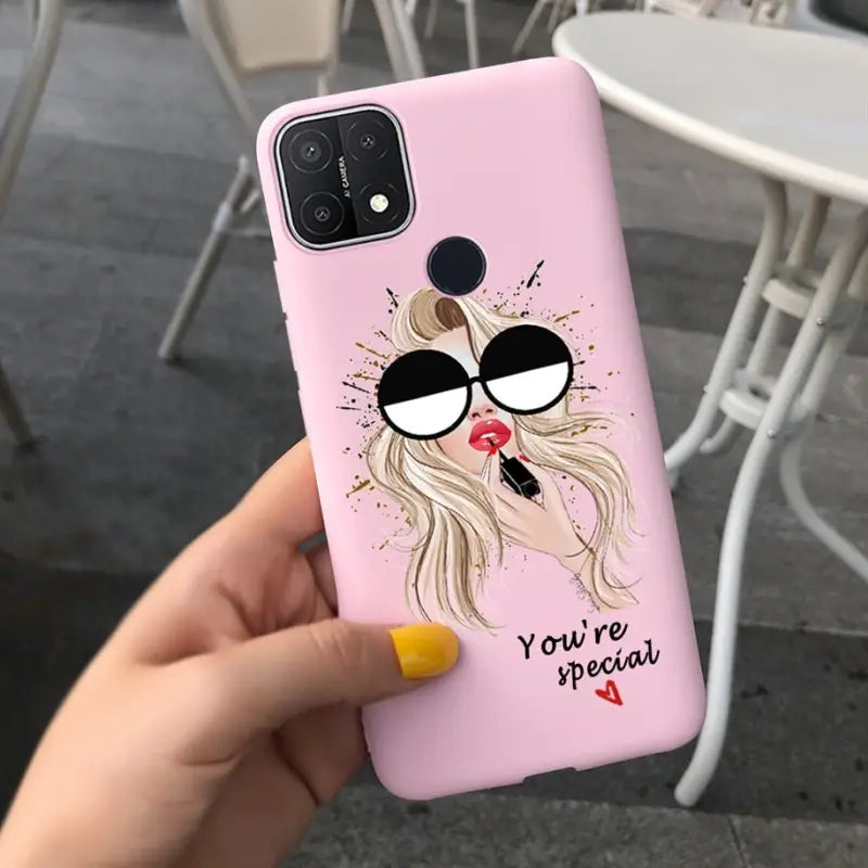 a girl with glasses and a heart phone case