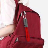a woman holding a red backpack