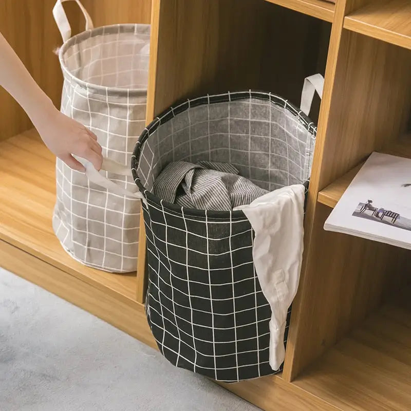 a woman putting a laundry basket in a wooden cabinet