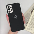 a woman holding a black phone case with a heart on it