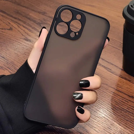 a woman holding a black iphone case