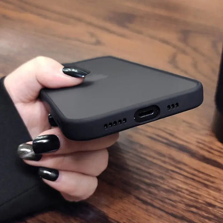 a woman holding a black phone case