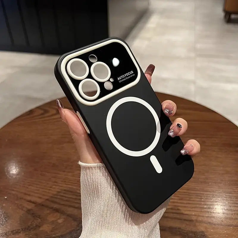 a woman holding a black phone case with a white ring on it