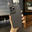 a person holding a black iphone case