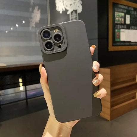 a person holding a black iphone case