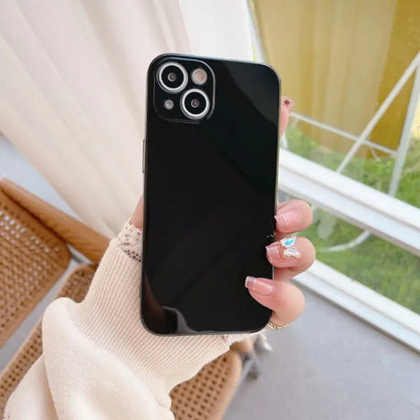 a woman holding a black phone case