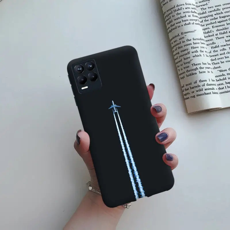 a woman holding a black phone case with a blue arrow on it
