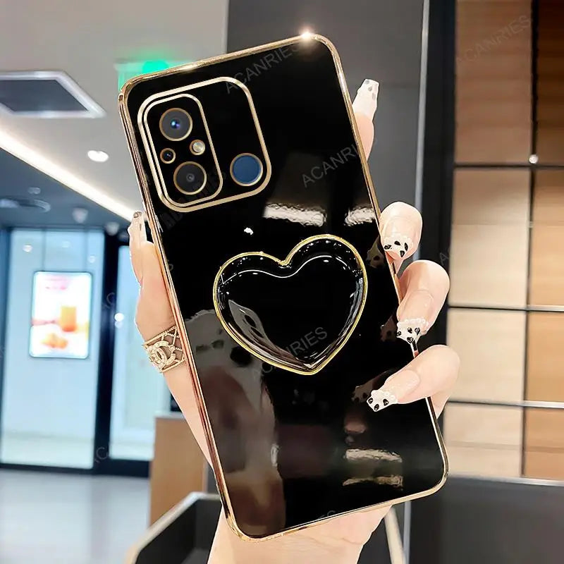 a woman holding a black phone with a heart on it