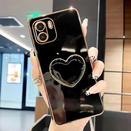 a woman holding a black phone with a heart on it