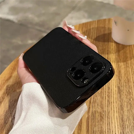 a hand holding a black phone case