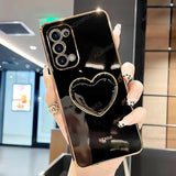 a woman holding a black phone with a heart on it