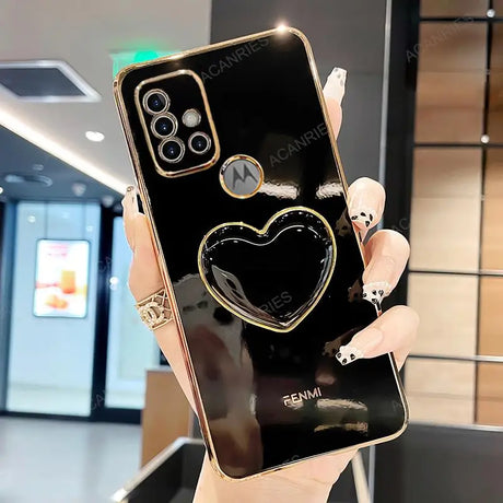 a woman holding a black phone with a heart on it