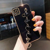 a woman holding a phone case with a chain