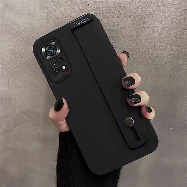 the back of a black case with a hand holding it